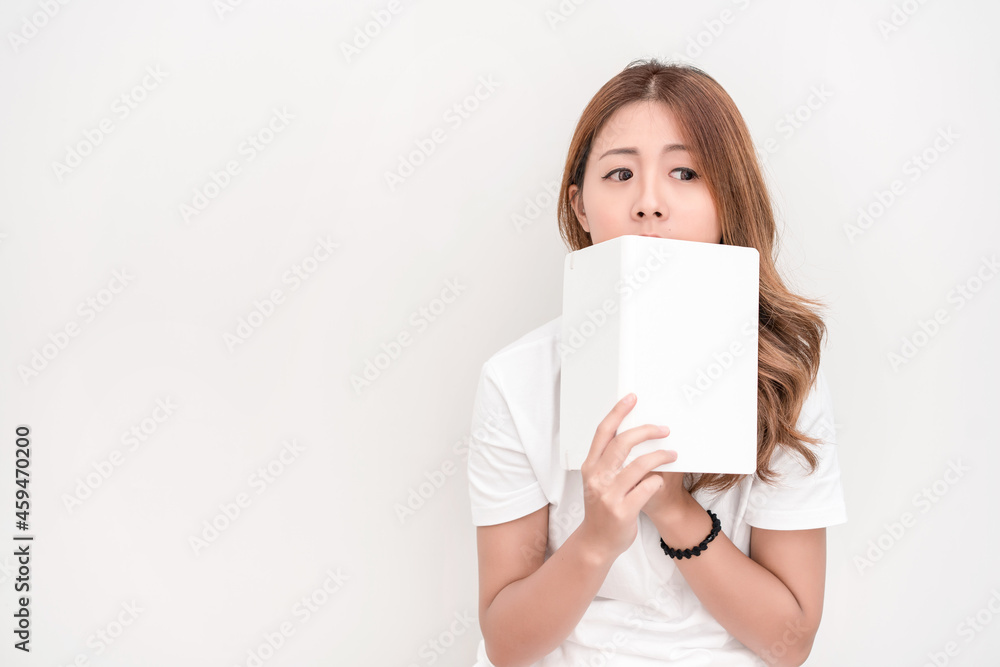 Young attractive asian student holding books in her arm on white background. School girl with a books to read for homework. Young attractive asian student holding books in her arm on white background. School girl with a books to read for homework.
