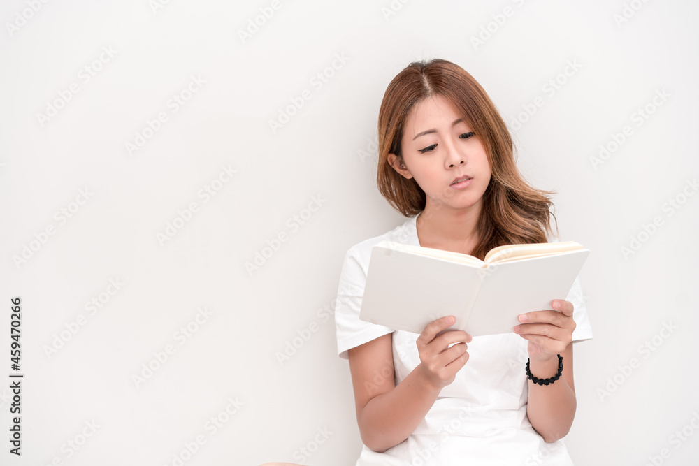 Young attractive asian student holding books in her arm on white background. School girl with a books to read for homework. Young attractive asian student holding books in her arm on white background. School girl with a books to read for homework.