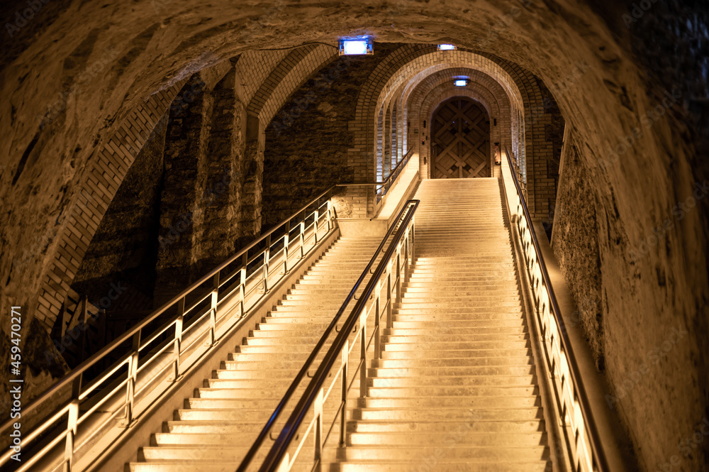 Staircase in deep and long undergrounds caves for making champagne sparkling wine from chardonnay and pinor noir grapes in Reims, Champagne, France