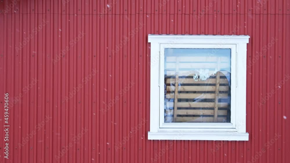 Snowing day with white window on red wall in fishing village Snowing day with white window on red wall in fishing village