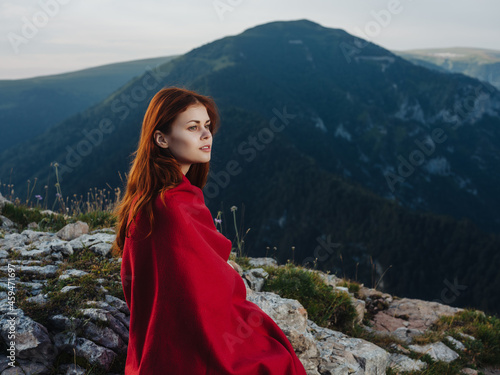 woman on the mountains hiding with a plaid vacation travel