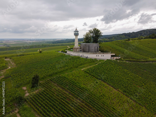 View on lighthouse and green pinot noir grand cru vineyards of famous champagne houses in Montagne de Reims near Verzenay, Champagne, France © barmalini