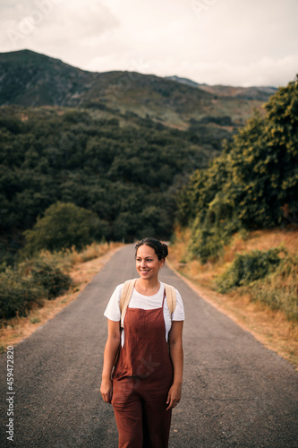 Smiling mature woman standing on road photo