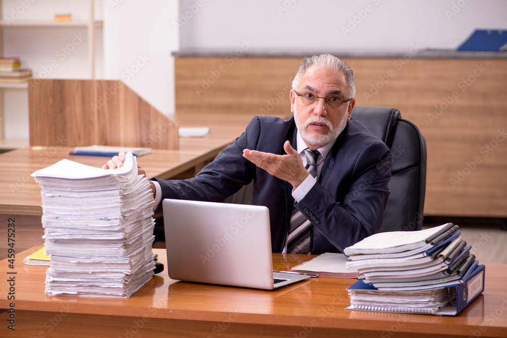 Old male employee and too much work in the office Old male employee and too much work in the office