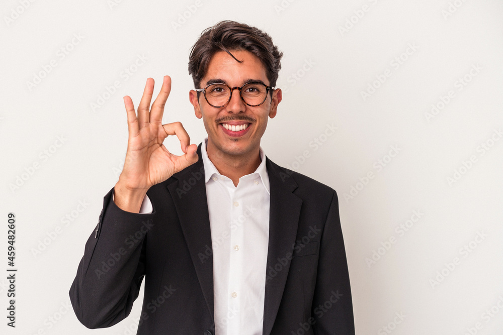 Young mixed race business man isolated on white background cheerful and confident showing ok gesture. Young mixed race business man isolated on white background cheerful and confident showing ok gesture.