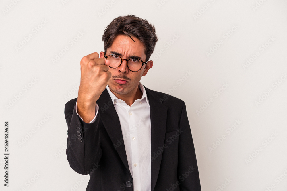 Young mixed race business man isolated on white background showing fist to camera, aggressive facial expression. Young mixed race business man isolated on white background showing fist to camera, aggressive facial expression.