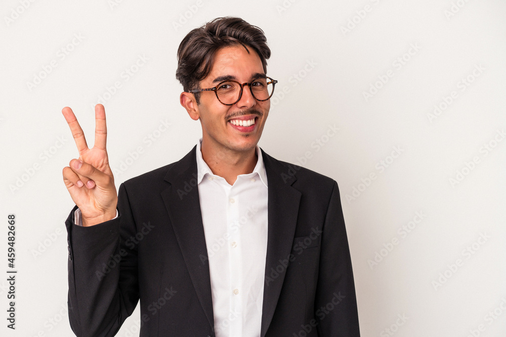 Young mixed race business man isolated on white background joyful and carefree showing a peace symbol with fingers. Young mixed race business man isolated on white background joyful and carefree showing a peace symbol with fingers.