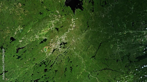 Sign of prehistoric asteroid impact on earth, green terrain around Sudbury Canada, aerial view from satellite sunrise animation. Based on images furnished by Nasa photo