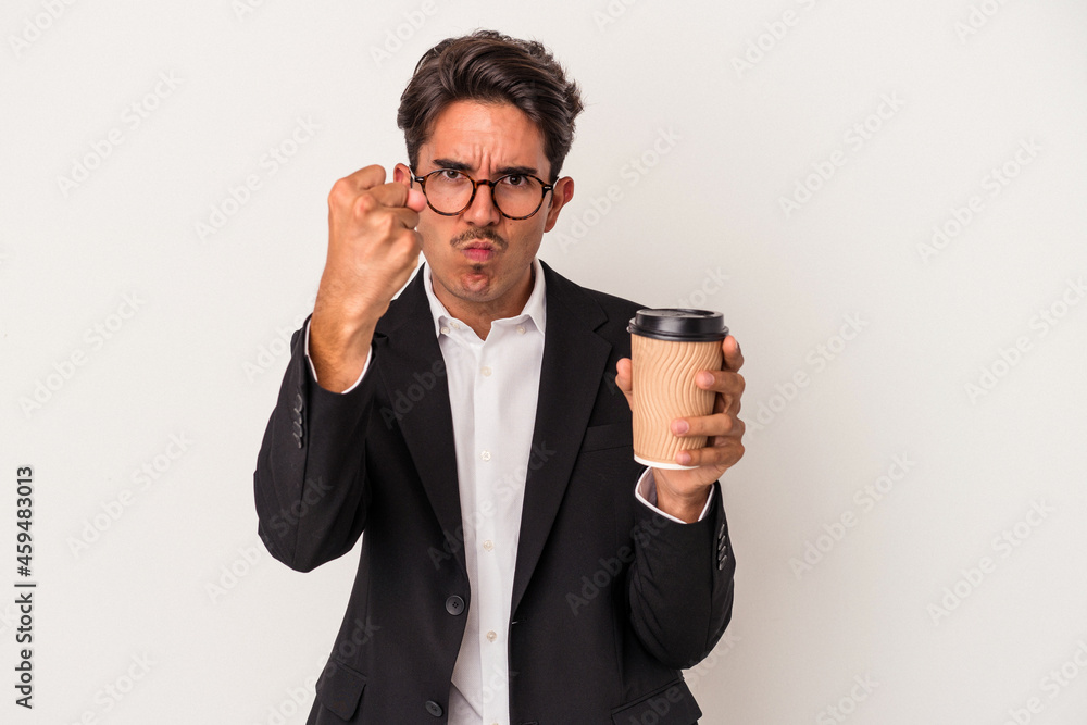Young mixed race business man holding take away coffee isolated on white background showing fist to camera, aggressive facial expression. Young mixed race business man holding take away coffee isolated on white background showing fist to camera, aggressive facial expression.