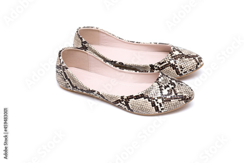 pair of female ballet flats made of reptile skin animal print isolate on white background close-up