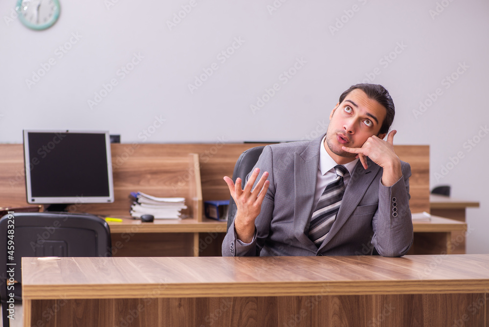 Young businessman employee sitting in the office Young businessman employee sitting in the office
