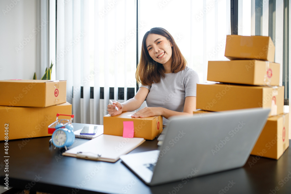 Portrait of Starting small businesses SME owners female entrepreneurs working on receipt box and check online orders to prepare to pack the boxes, sell to customers, sme business ideas online. Portrait of Starting small businesses SME owners female entrepreneurs working on receipt box and check online orders to prepare to pack the boxes, sell to customers, sme business ideas online.