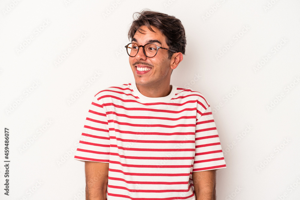 Young mixed race man isolated on white background laughs and closes eyes, feels relaxed and happy. Young mixed race man isolated on white background laughs and closes eyes, feels relaxed and happy.