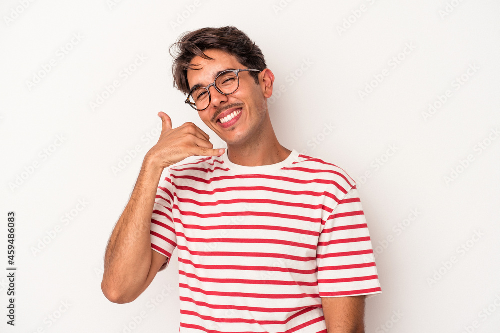 Young mixed race man isolated on white background showing a mobile phone call gesture with fingers. Young mixed race man isolated on white background showing a mobile phone call gesture with fingers.