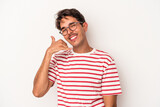 Young mixed race man isolated on white background showing a mobile phone call gesture with fingers.