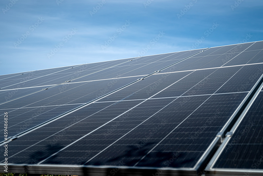 against the background of a beautiful blue sky new clean energy saving solar panels stand against the background of a beautiful blue sky new clean energy saving solar panels stand