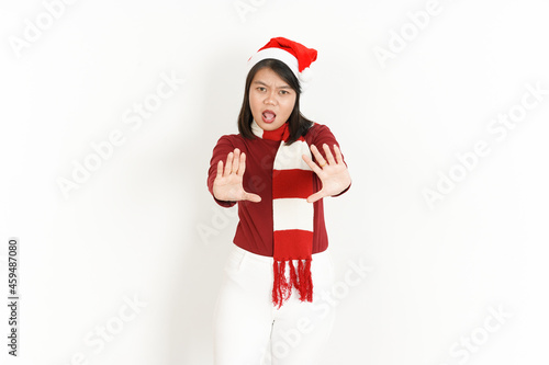 Stop Hand Gesture of Beautiful Asian Woman Wearing Red Turtleneck and Santa Hat Isolated On White Background