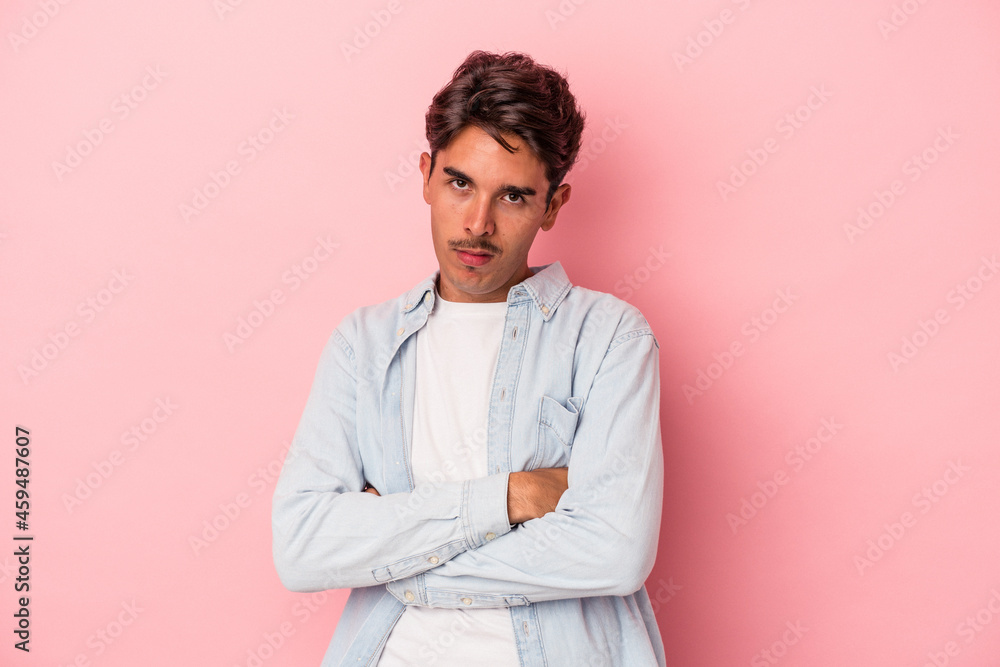 Young mixed race man isolated on white background who is bored, fatigued and need a relax day. Young mixed race man isolated on white background who is bored, fatigued and need a relax day.