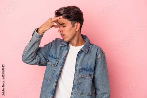 Young mixed race man isolated on white background having a head ache, touching front of the face.