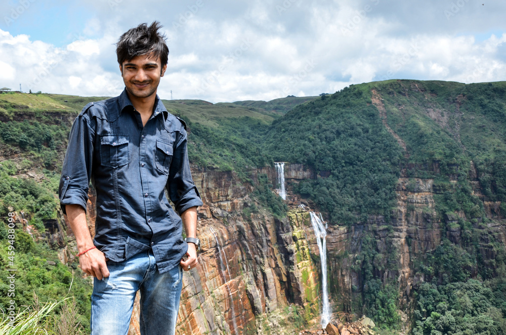 Young man standing and happy with the fresh and mind-blowing beauty of nature.