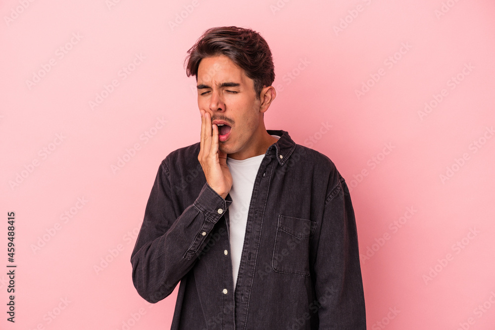 Young mixed race man isolated on white background yawning showing a tired gesture covering mouth with hand.