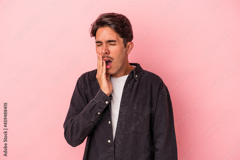 Young mixed race man isolated on white background yawning showing a tired gesture covering mouth with hand. Young mixed race man isolated on white background yawning showing a tired gesture covering mouth with hand.