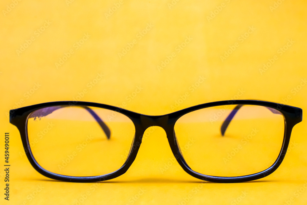 glasses on a yellow background glasses on a yellow background
