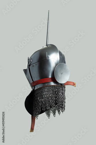 Medieval knightly Milanese helmet with a heraldic kleinod in the form of a swan and a crown, period of the 15th century, on a light background. photo