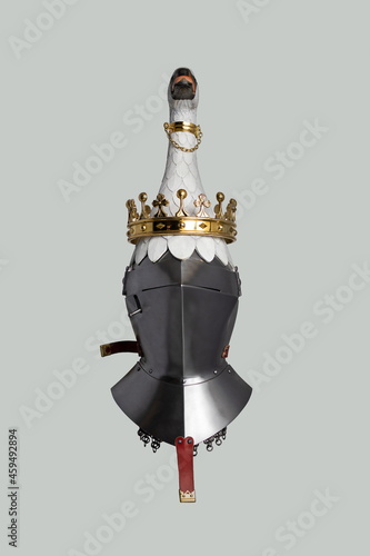 Medieval knightly Milanese helmet with a heraldic kleinod in the form of a swan and a crown, period of the 15th century, on a light background. photo