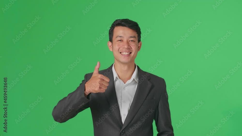 Happy Asian Business Man Showing Thumbs Up Gesture While Standing In The Green Screen Studio
Happy Asian Business Man Showing Thumbs Up Gesture While Standing In The Green Screen Studio