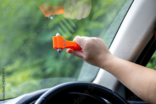 Fotografi Woman use Safety Hammer and Seatbelt Cutter in Cars, break glass When emergency