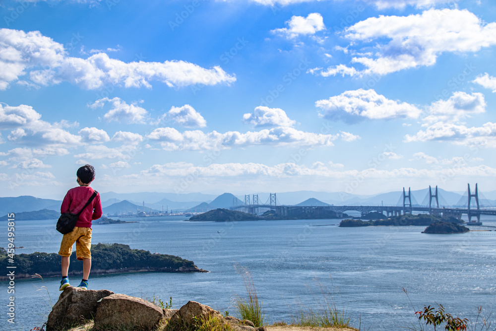 瀬戸大橋・瀬戸内海を岩の上に立って眺める男の子 岡山県倉敷市 An Asian boy standing on the rock and watching the view of Setonaikai, Inland Sea of Japan, and Seto Ohashi bridge in Kurashiki city, Okayama pref. Japan. 瀬戸大橋・瀬戸内海を岩の上に立って眺める男の子 岡山県倉敷市 An Asian boy standing on the rock and watching the view of Setonaikai, Inland Sea of Japan, and Seto Ohashi bridge in Kurashiki city, Okayama pref. Japan.