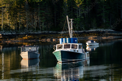Maine Lobster Boats Moored in a Harbour of Calm Water with a Floating Deck Full of Lobster Traps 