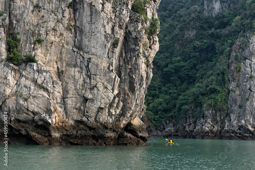 Kayaking by the rock formations in Ha Long Bay, Vietnam