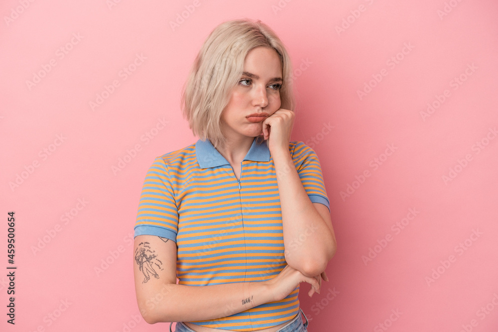 Young caucasian woman isolated on pink background who feels sad and pensive, looking at copy space. Young caucasian woman isolated on pink background who feels sad and pensive, looking at copy space.