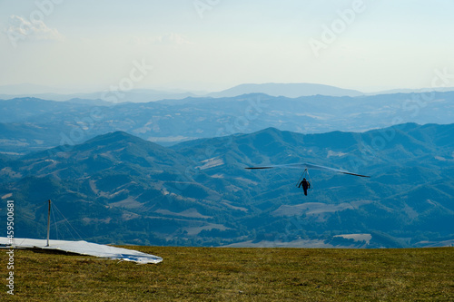 Hang glider just after launch from Monte Cucco Regional Park, Umbria, Italy