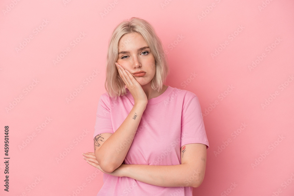 Young caucasian woman isolated on pink background who is bored, fatigued and need a relax day. Young caucasian woman isolated on pink background who is bored, fatigued and need a relax day.
