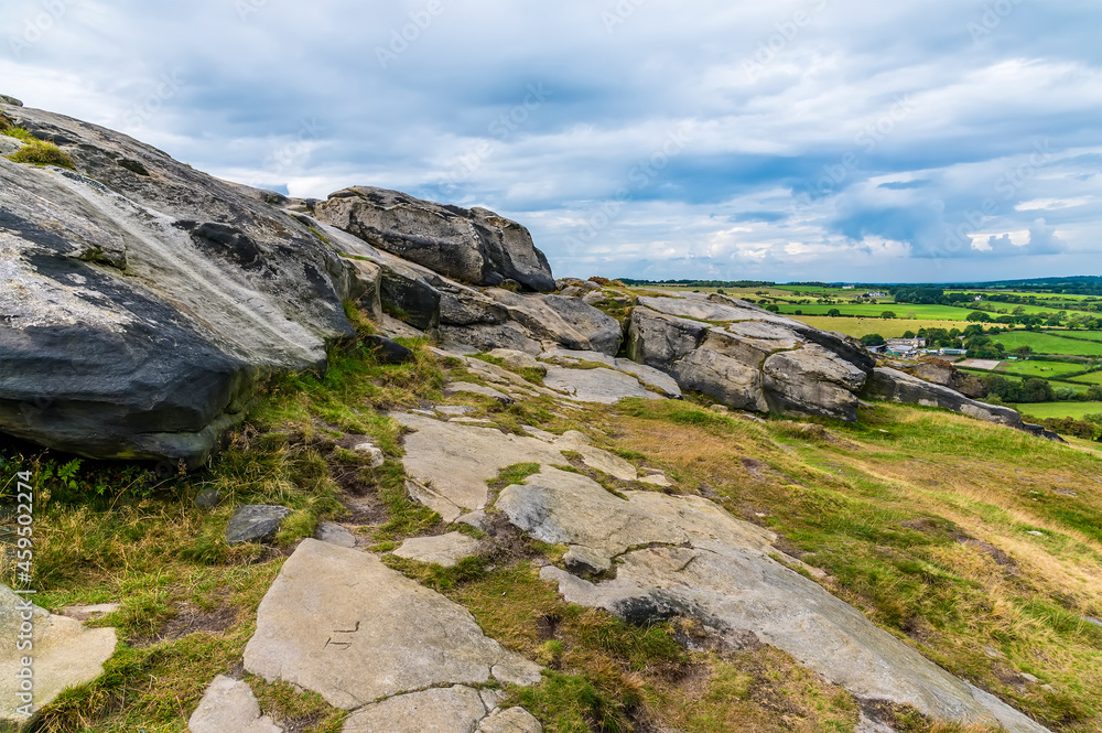 A view along the side of the eastern summit of the Almscliffe crag in Yorkshire, UK in summertime