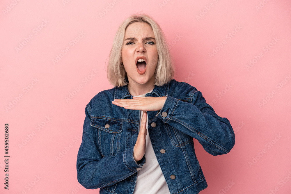 Young caucasian woman isolated on pink background showing a timeout gesture. Young caucasian woman isolated on pink background showing a timeout gesture.