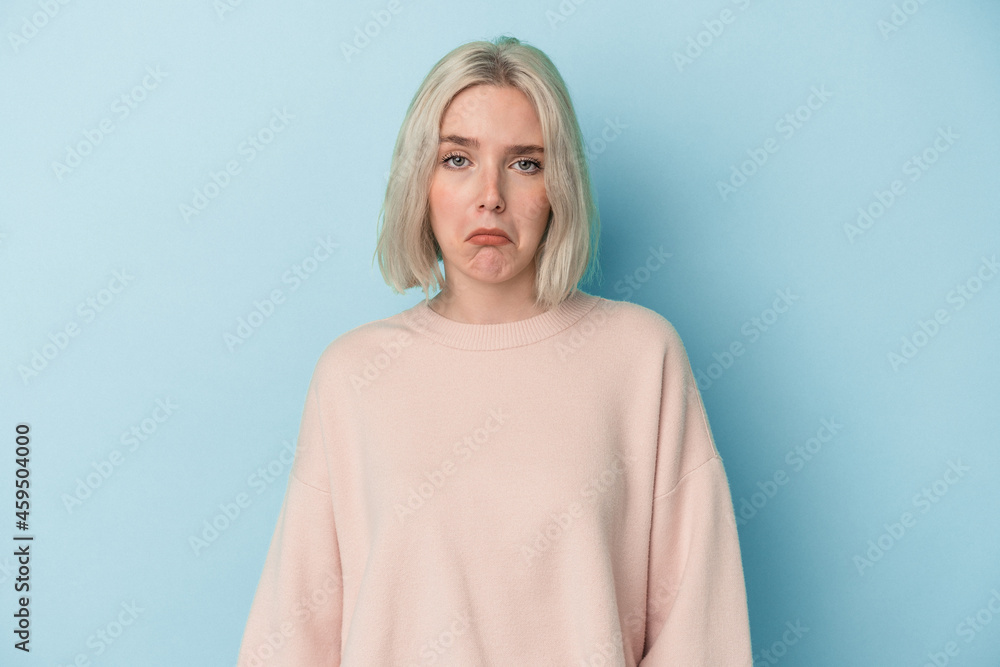 Young caucasian woman isolated on blue background sad, serious face, feeling miserable and displeased. Young caucasian woman isolated on blue background sad, serious face, feeling miserable and displeased.