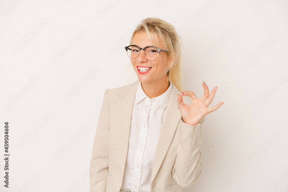 Young business Russian woman isolated on white background cheerful and confident showing ok gesture. Young business Russian woman isolated on white background cheerful and confident showing ok gesture.