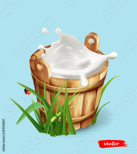 Wooden milk bucket with splash of milk. Natural dairy product. Concept for package of milk. Milk can with green grass.
