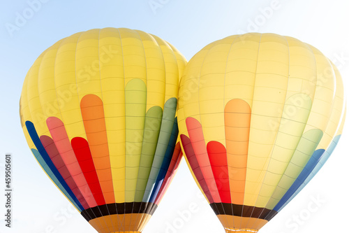 two air hot balloons in green, blue, red  and yellow colors