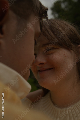 Face to face portrait of young couple with Down Syndrome and Foetal Alcohol Syndrome smiling