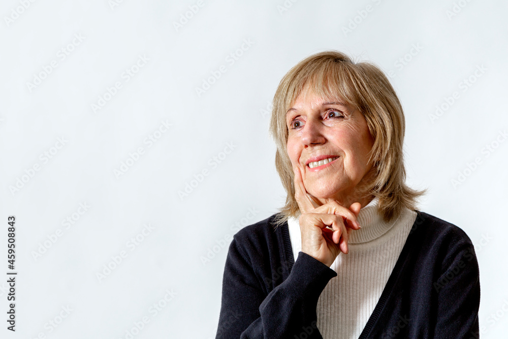 Having an idea. Elderly woman in thinking position with the hand on the face. White background. Around 65 years woman. Having an idea. Elderly woman in thinking position with the hand on the face. White background. Around 65 years woman.