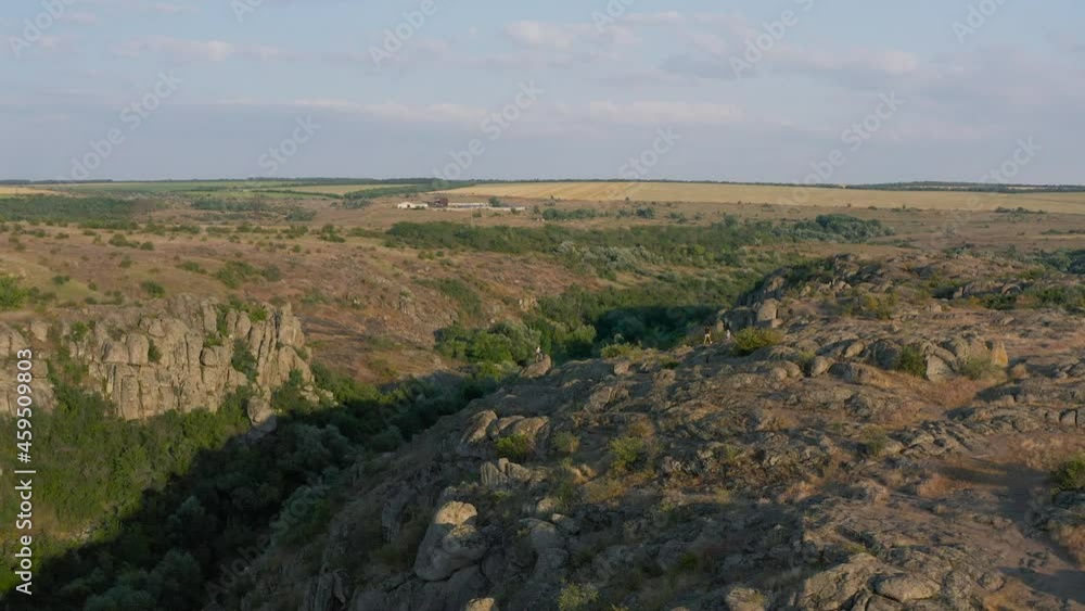 Aktovsky canyon of the Mertvovod river from a bird's eye view. Drone shooting white stone, green trees, cloudy blue sky, a shallow river flows at the bottom of the canyon. Aktovsky canyon of the Mertvovod river from a bird's eye view. Drone shooting white stone, green trees, cloudy blue sky, a shallow river flows at the bottom of the canyon.