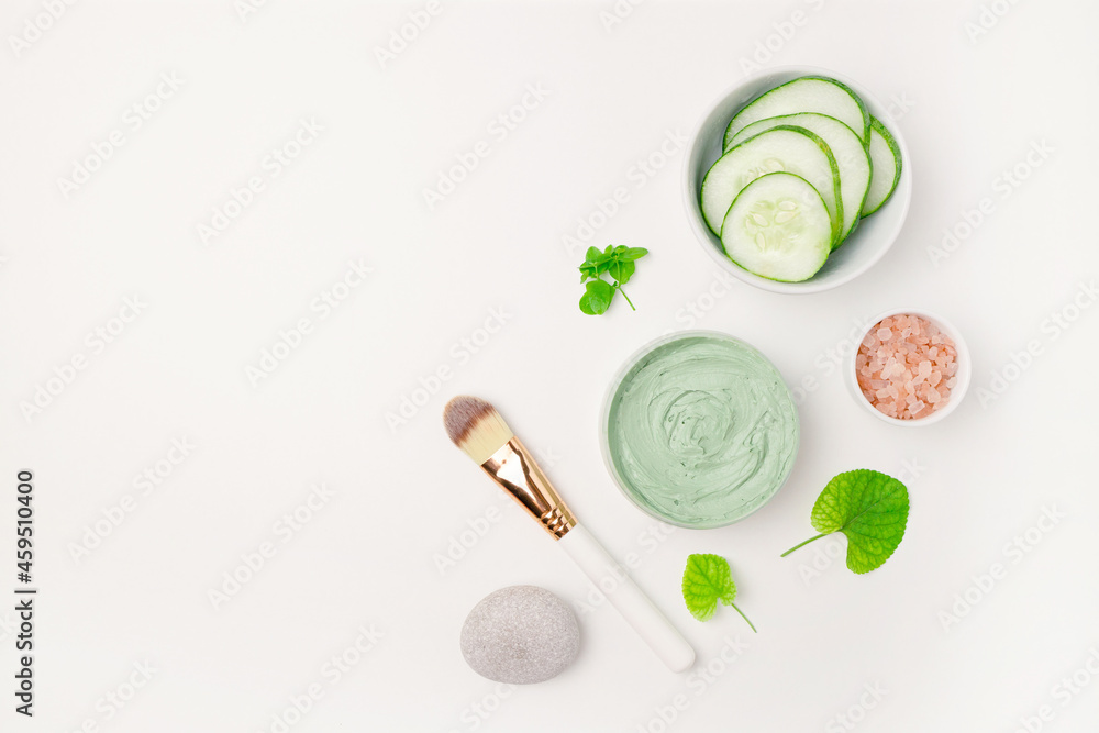 Cosmetic glass bottle, jar with nature eco cream and moisturizer tube with herbal ingredients on white surface. Skin care product flat lay. Cosmetic glass bottle, jar with nature eco cream and moisturizer tube with herbal ingredients on white surface. Skin care product flat lay.