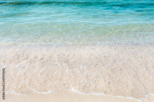 Crystal clear sea water and white sand. Waves on the coast. Caribbean sea and tropical holidays. Holiday wallpaper.