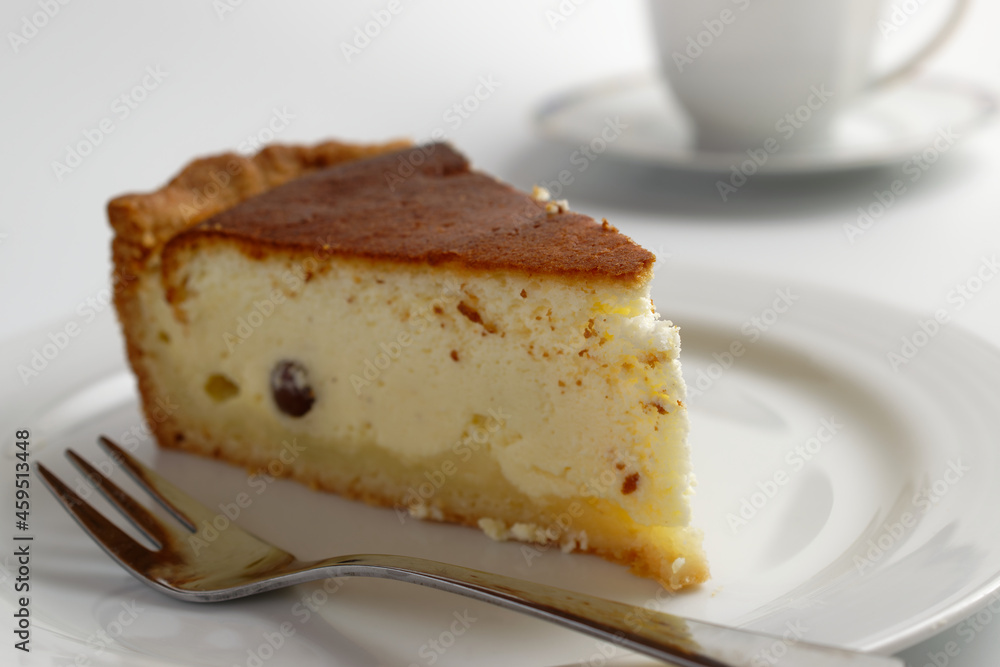Homemade cheesecake and a cup of coffee on white background Homemade cheesecake and a cup of coffee on white background