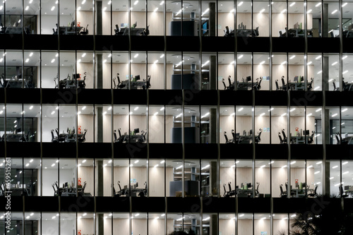 View of numerous empty workstations in an office building at the end of the working day